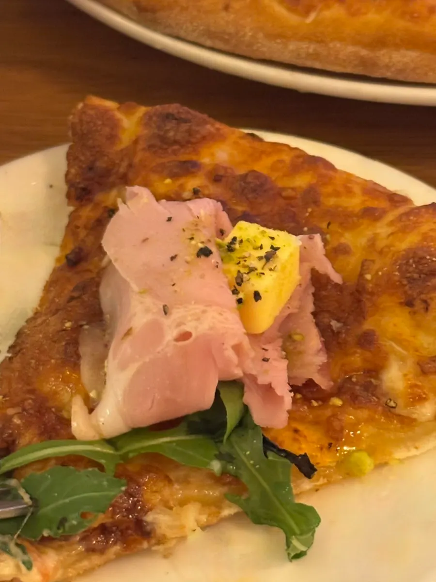 Jambon-beurre pizza topped with jambon ham, butter, and arugula