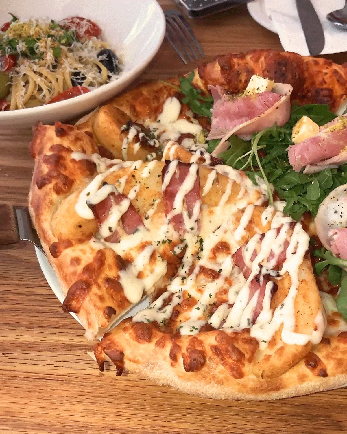 A slice of potato pizza with stretchy cheese