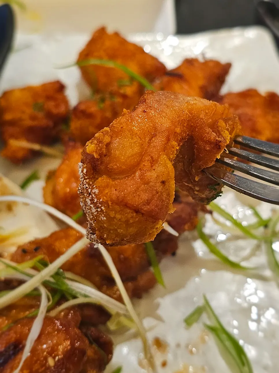Chopsticks picking up a piece of original Fix Chicken