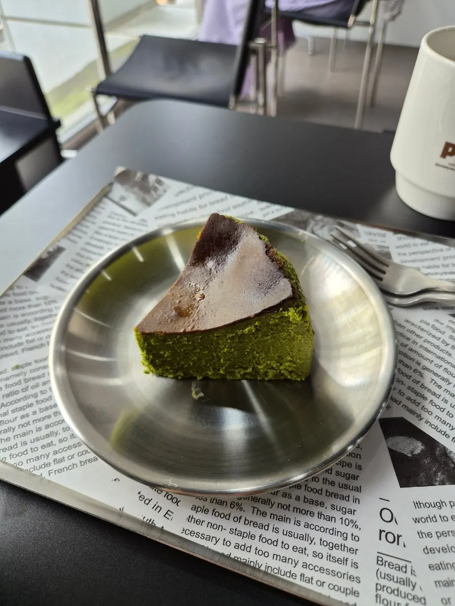 A slice of deep green matcha basque cheesecake