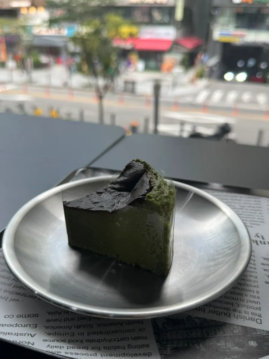 Cross-section of the matcha basque cheesecake cut with a fork