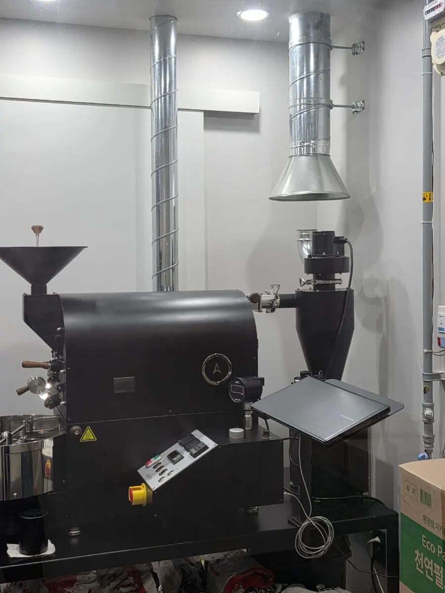 Large coffee roasting machine on display at the front of the store