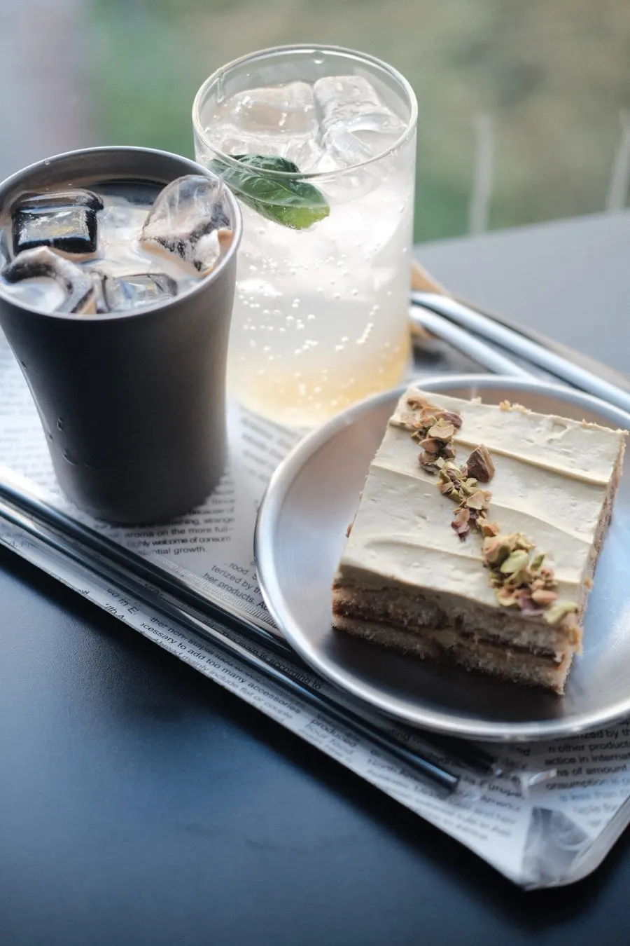 Pistachio tiramisu served on newspaper-like paper