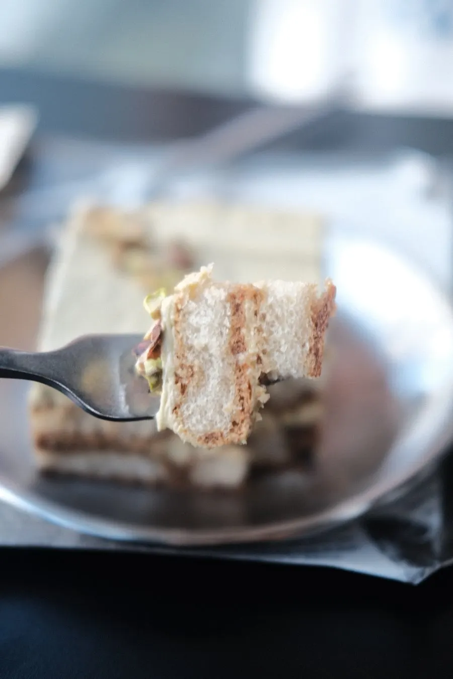 Cross-section of a spoonful of pistachio tiramisu