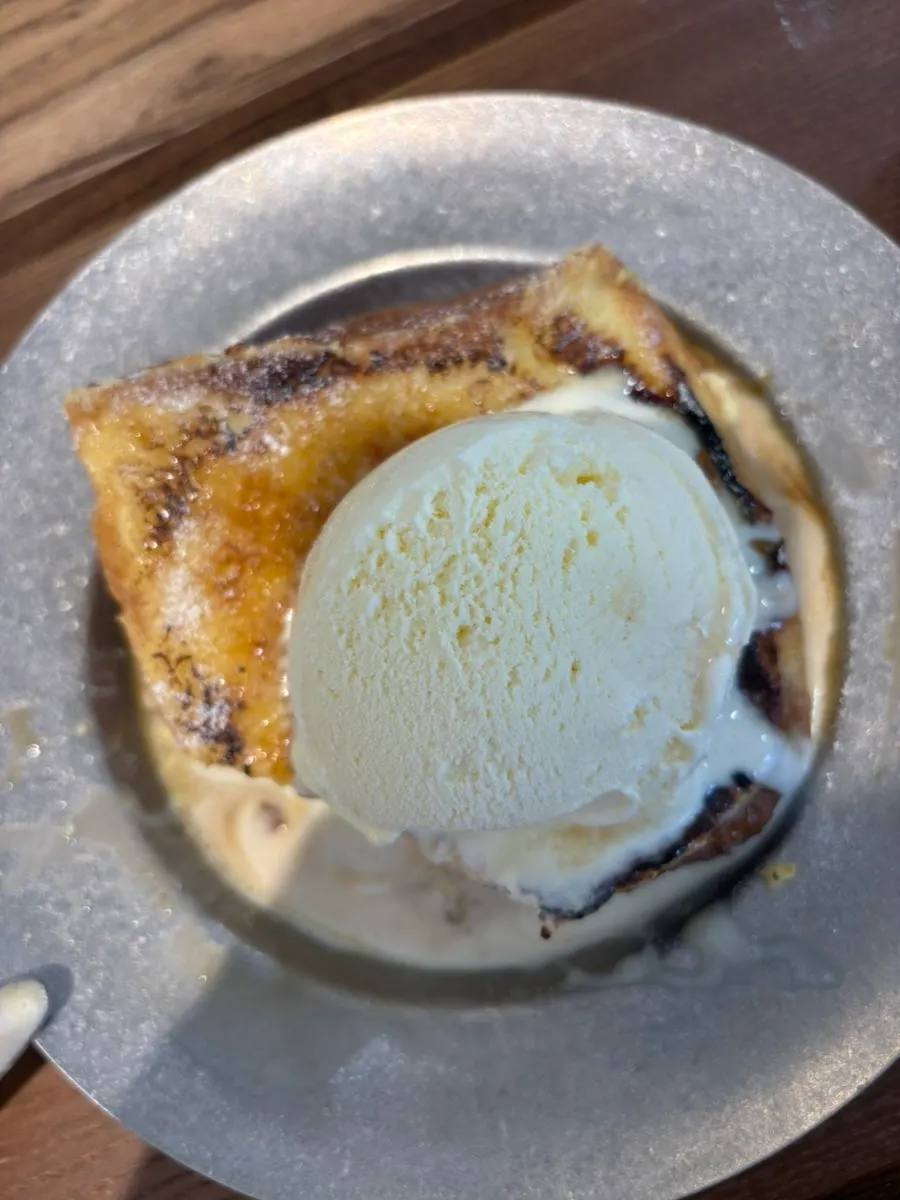 Thick aged French toast topped with ice cream