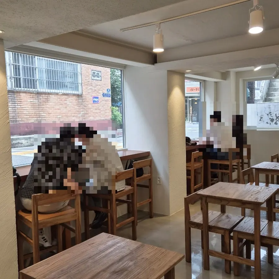 Café interior decorated in white and wood tones