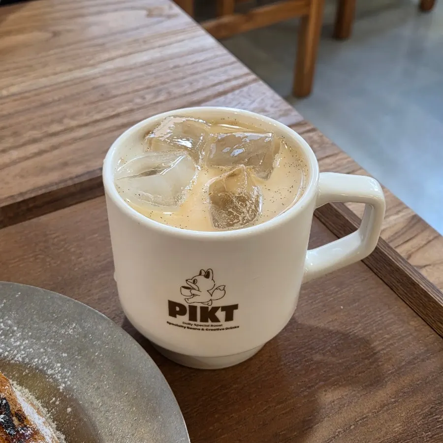 Iced latte showing visible vanilla bean flecks