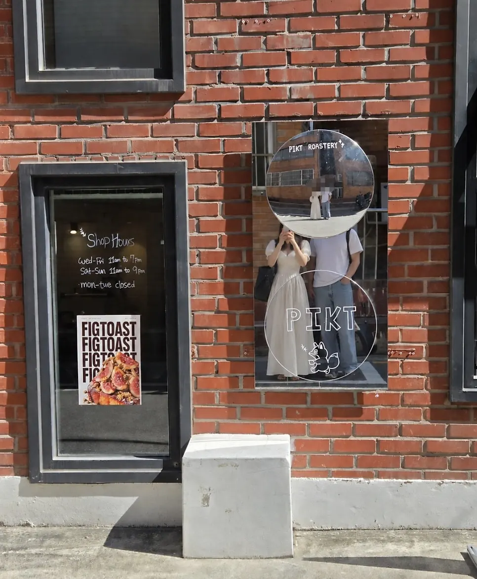 Exterior of PICT Roastery Mangwon Branch with a fig French toast poster