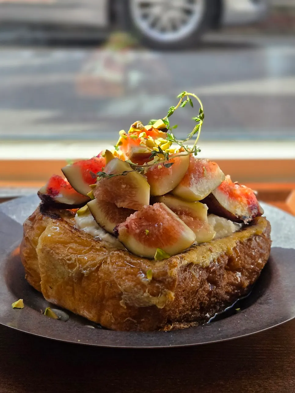 A slice of French toast served with fresh fig topping