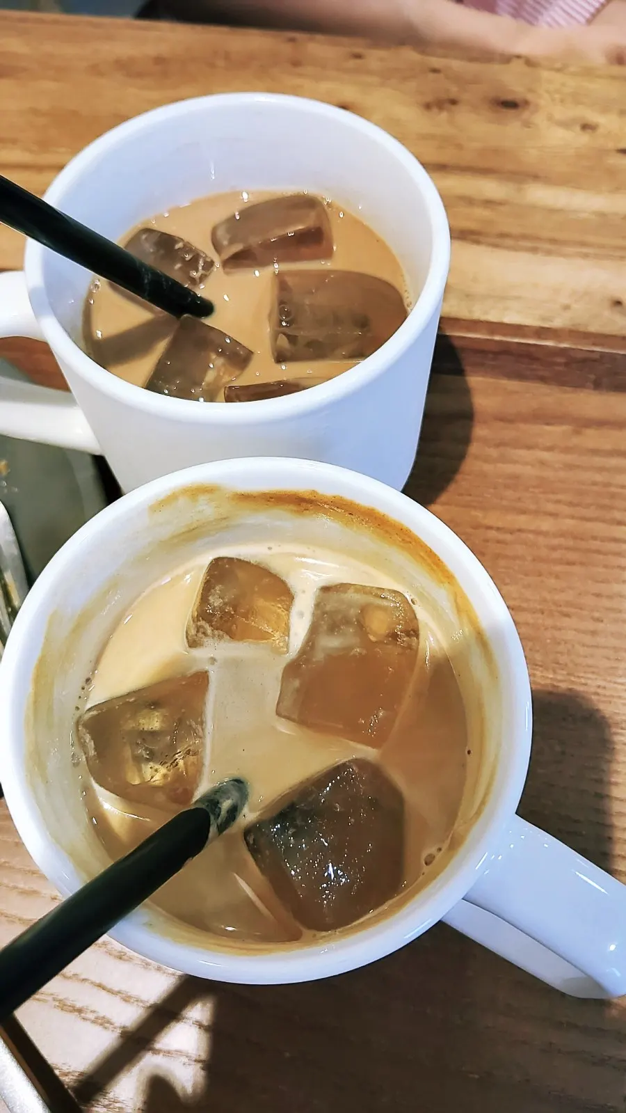 Iced coffee cup placed by the big window