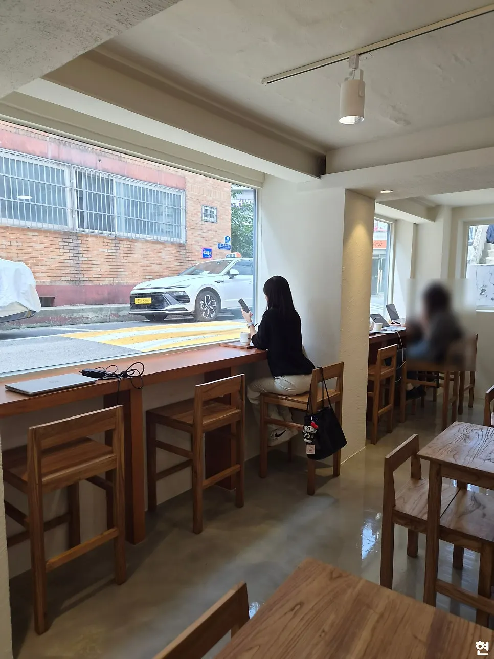 Interior of PICT Roastery Mangwon Branch decorated with wood-tone furniture