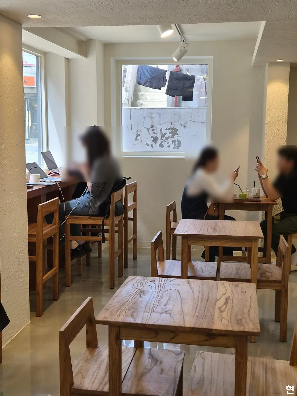 Floor-to-ceiling window seats at PICT overlooking the Mangwon-dong alley
