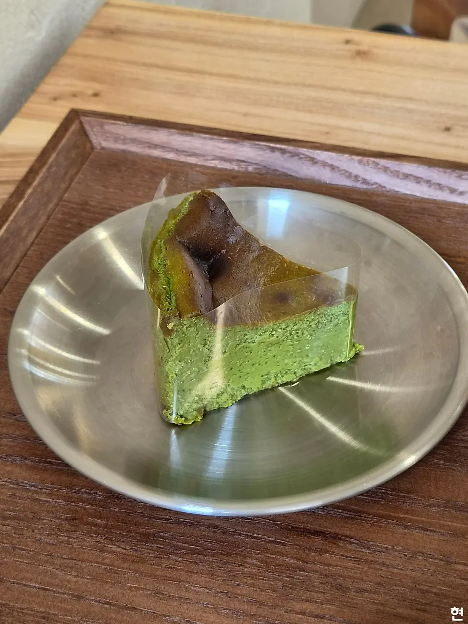 Close-up of the moist cross-section of the matcha Basque cheesecake