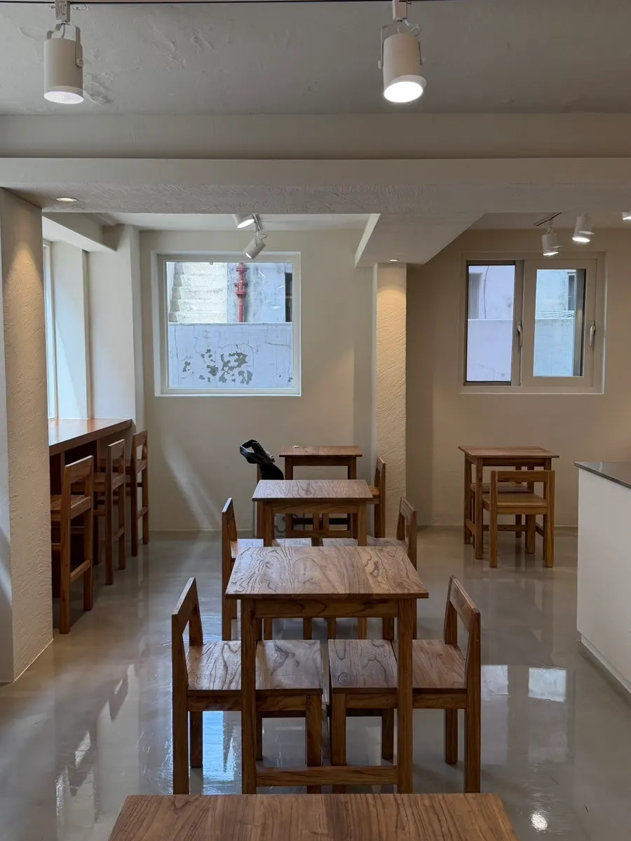 Interior of PICT Roastery Mangwon Branch with wood-toned tables