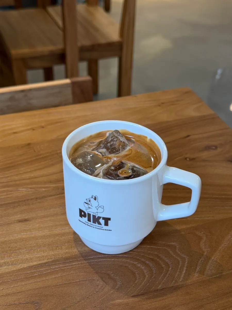 Iced café latte with a large ice cube at PICT Roastery