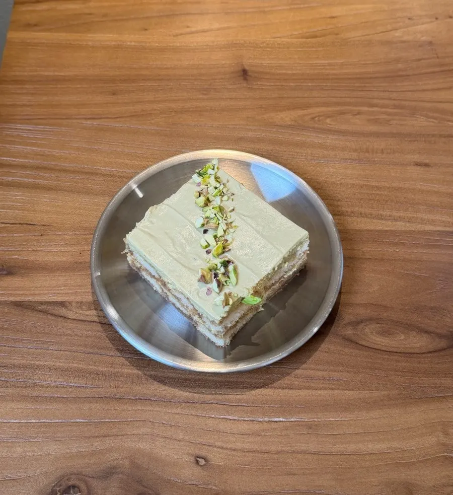 Tiramisu topped with pistachio cream