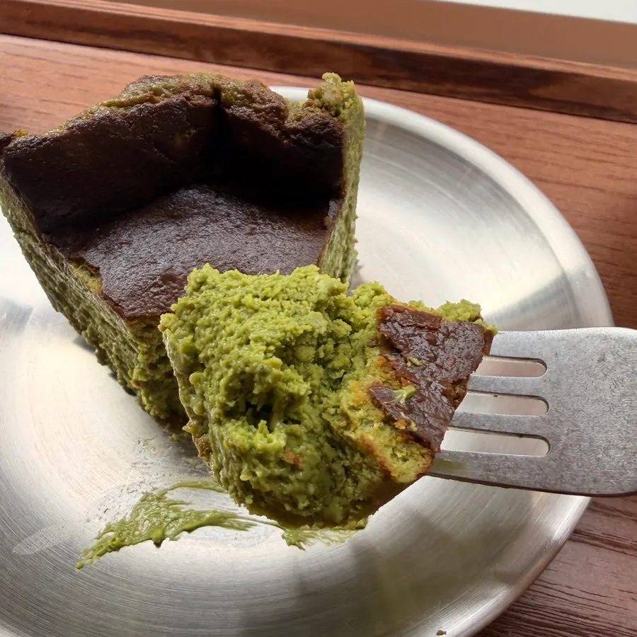 A forkful of matcha Basque cheesecake