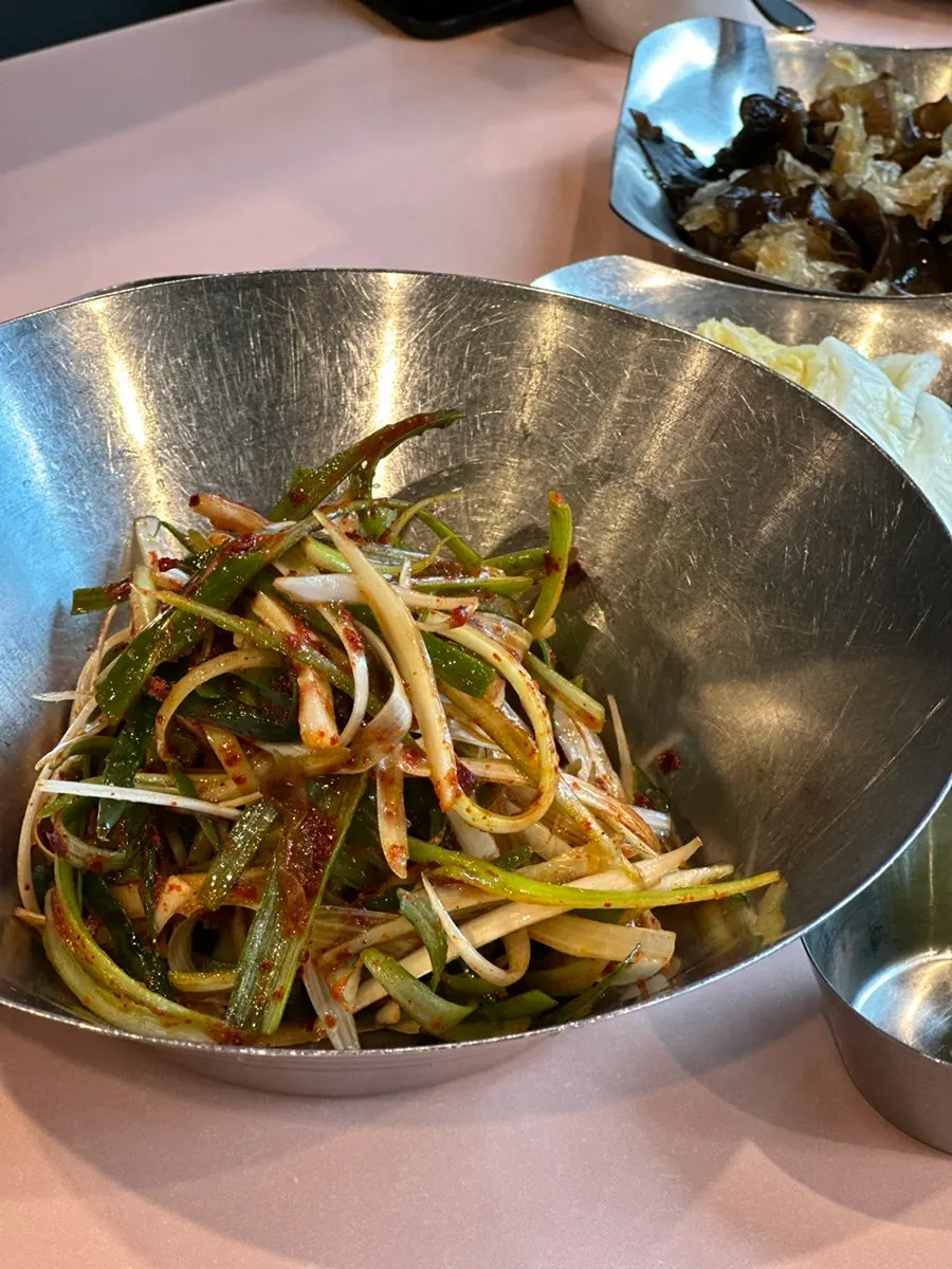 Generous side dishes including seasoned mushrooms and sauces
