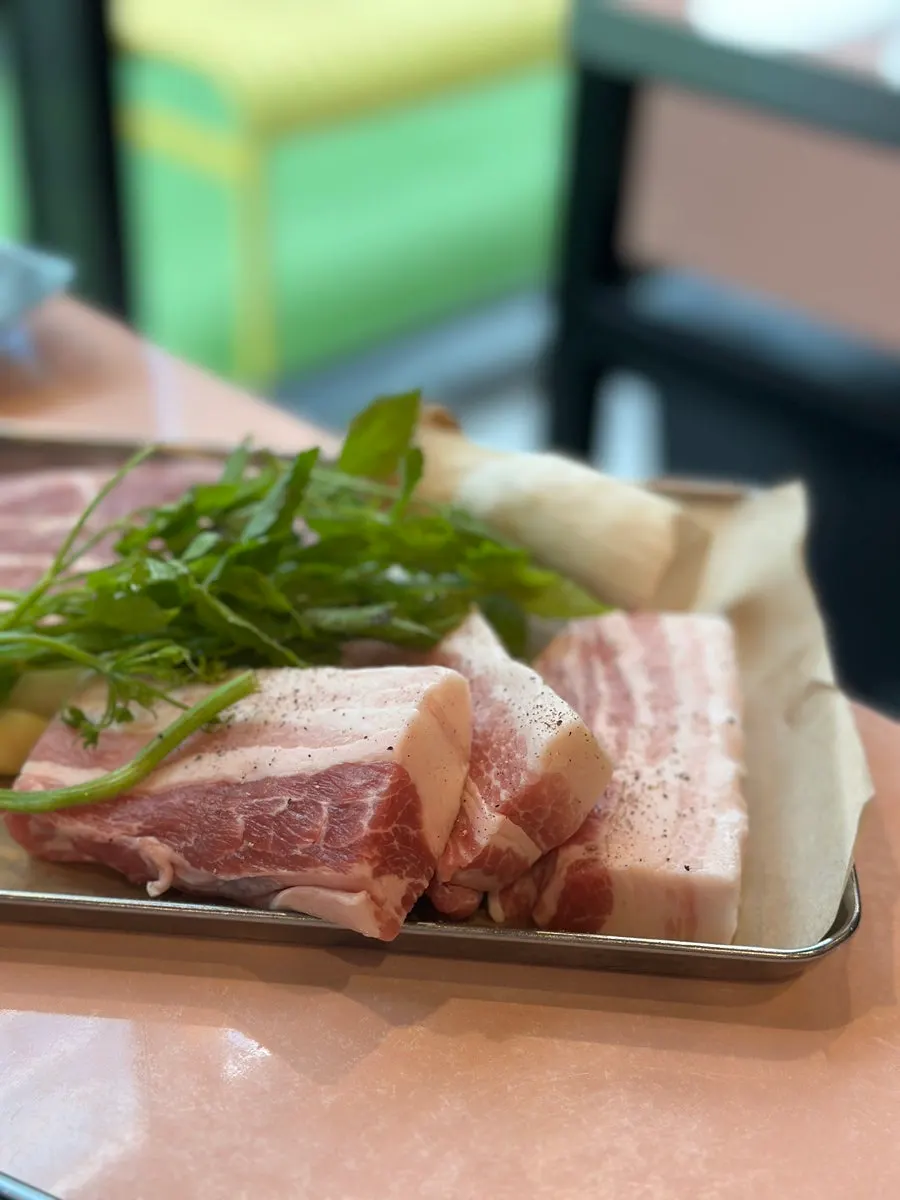 Staff grilling pork belly at the table