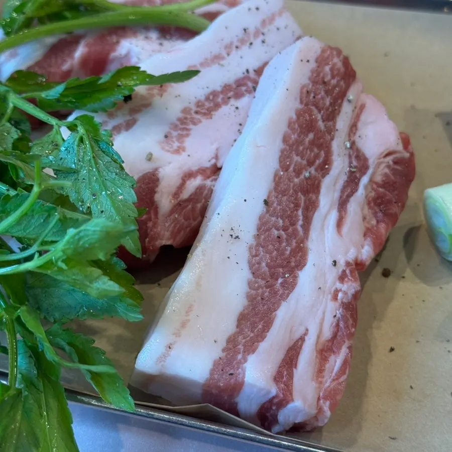 Vividly pink raw pork belly