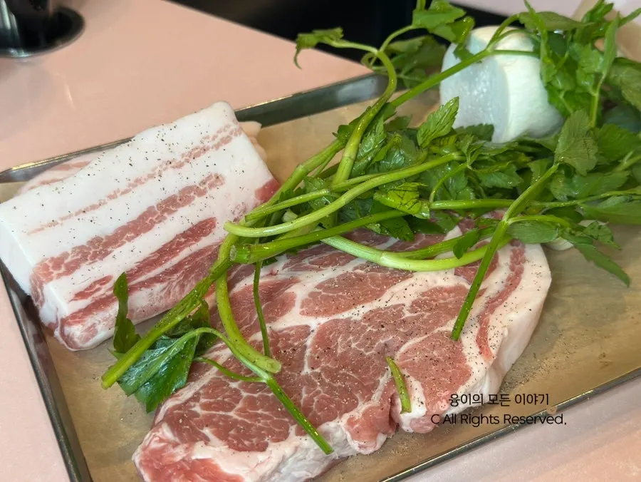 Plate of raw meat served with minari and king oyster mushroom