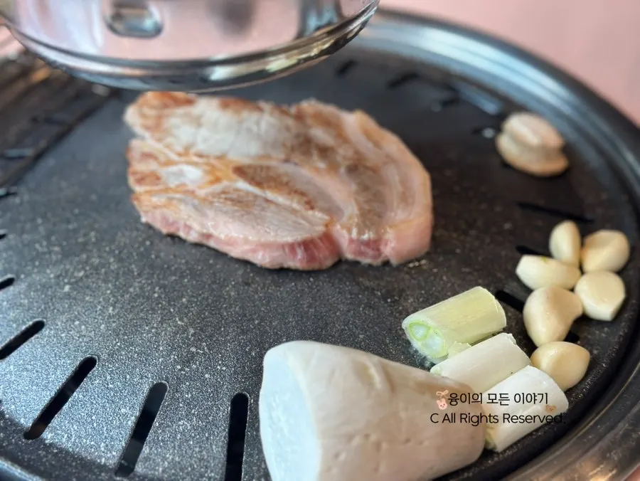 Signature pork neck and king oyster mushroom grilling on the pan