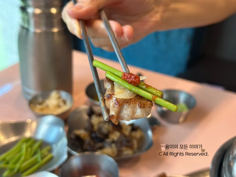 A piece of pork neck topped with roasted salt