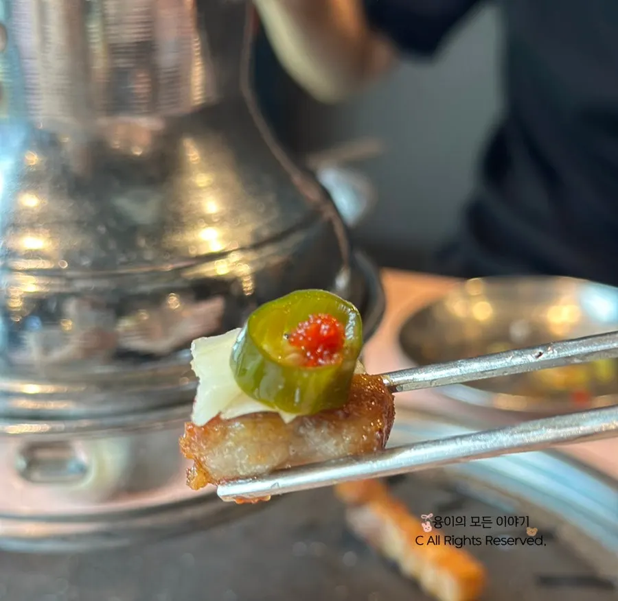 Pork neck topped with herring roe and garlic scapes