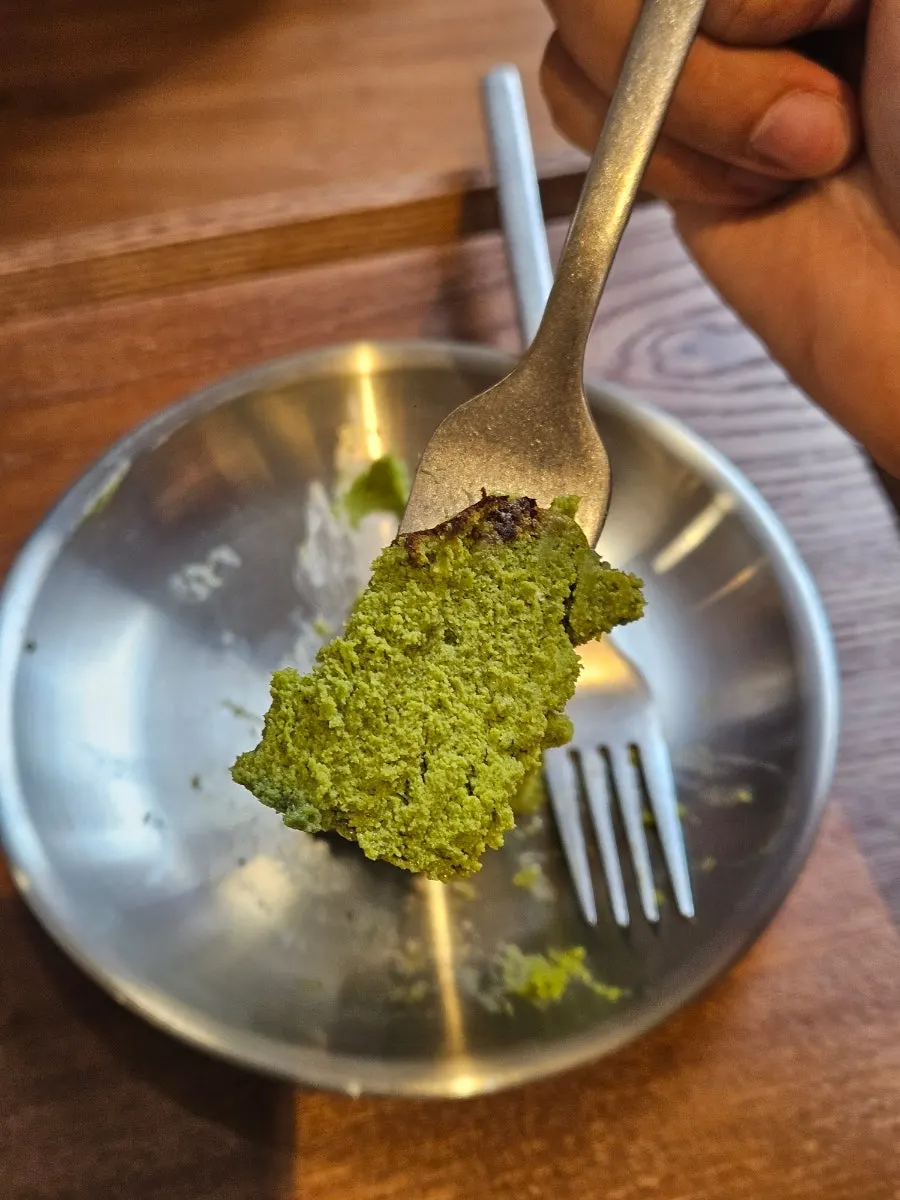 Close-up of deep matcha-colored Basque cheesecake