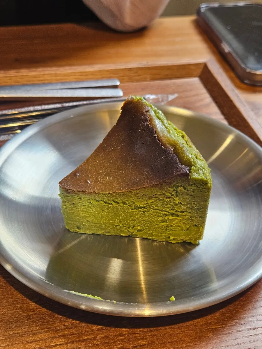 Matcha Basque cheesecake with a bite taken out
