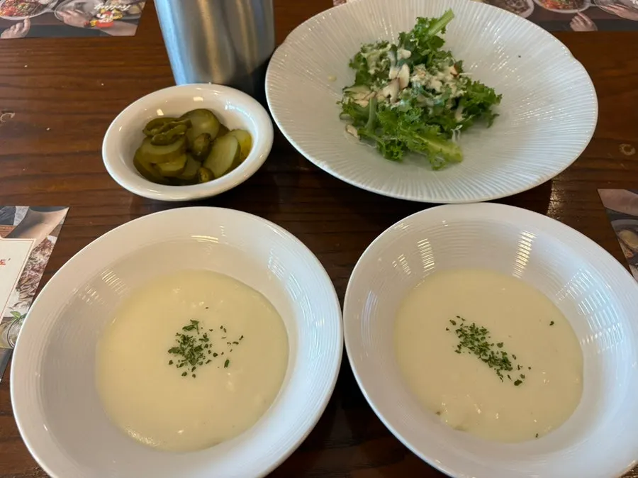 Standard salad, pickles, and soup served with the meal
