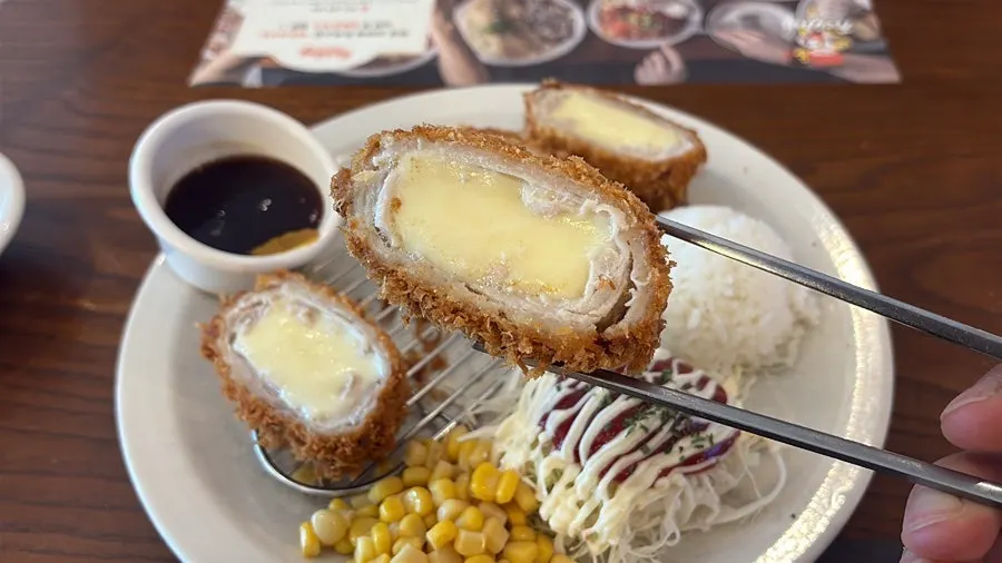 Cross-section of whole cheese katsu showing melted cheese