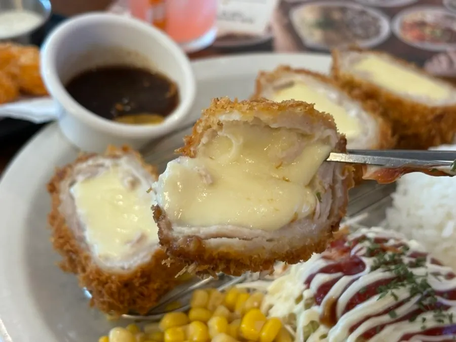 A piece of whole cheese katsu with stretchy cheese