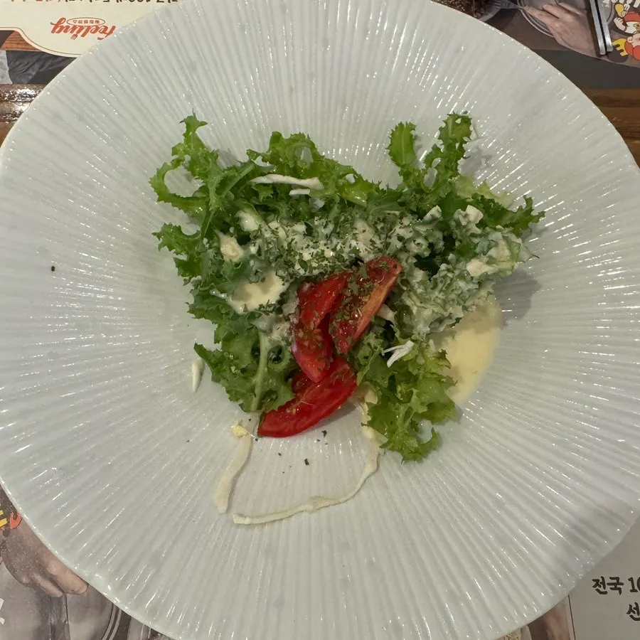 A plate of salad with dressing