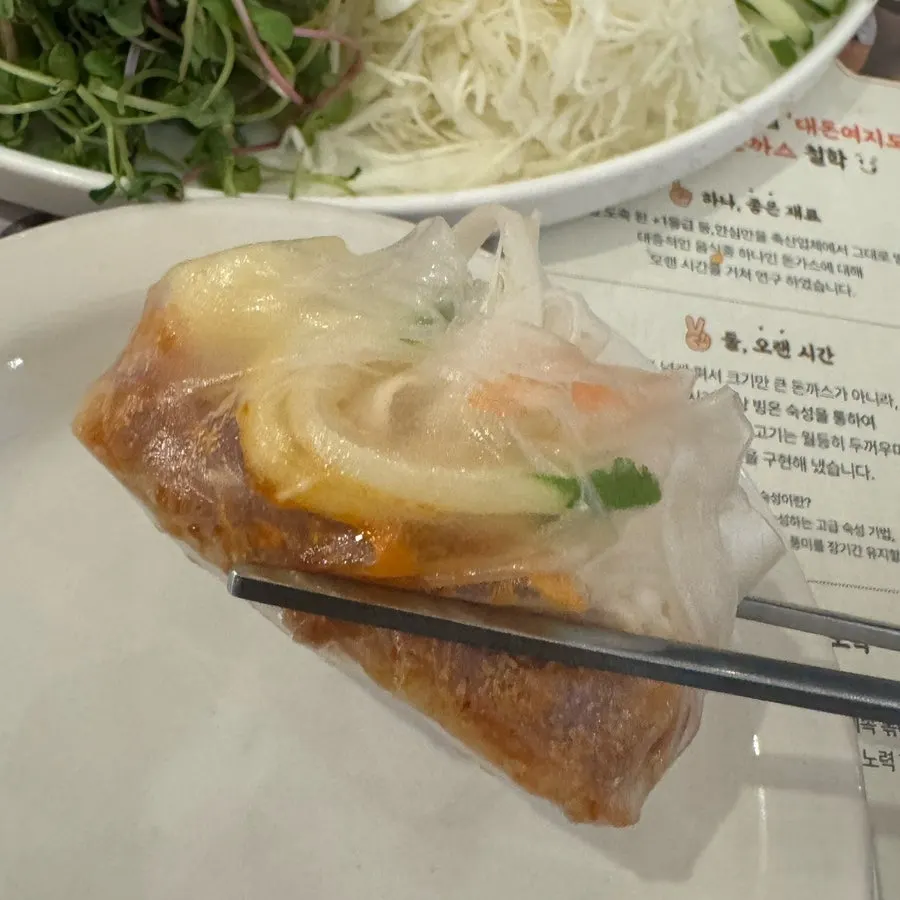Katsu and vegetables piled onto a sheet of rice paper