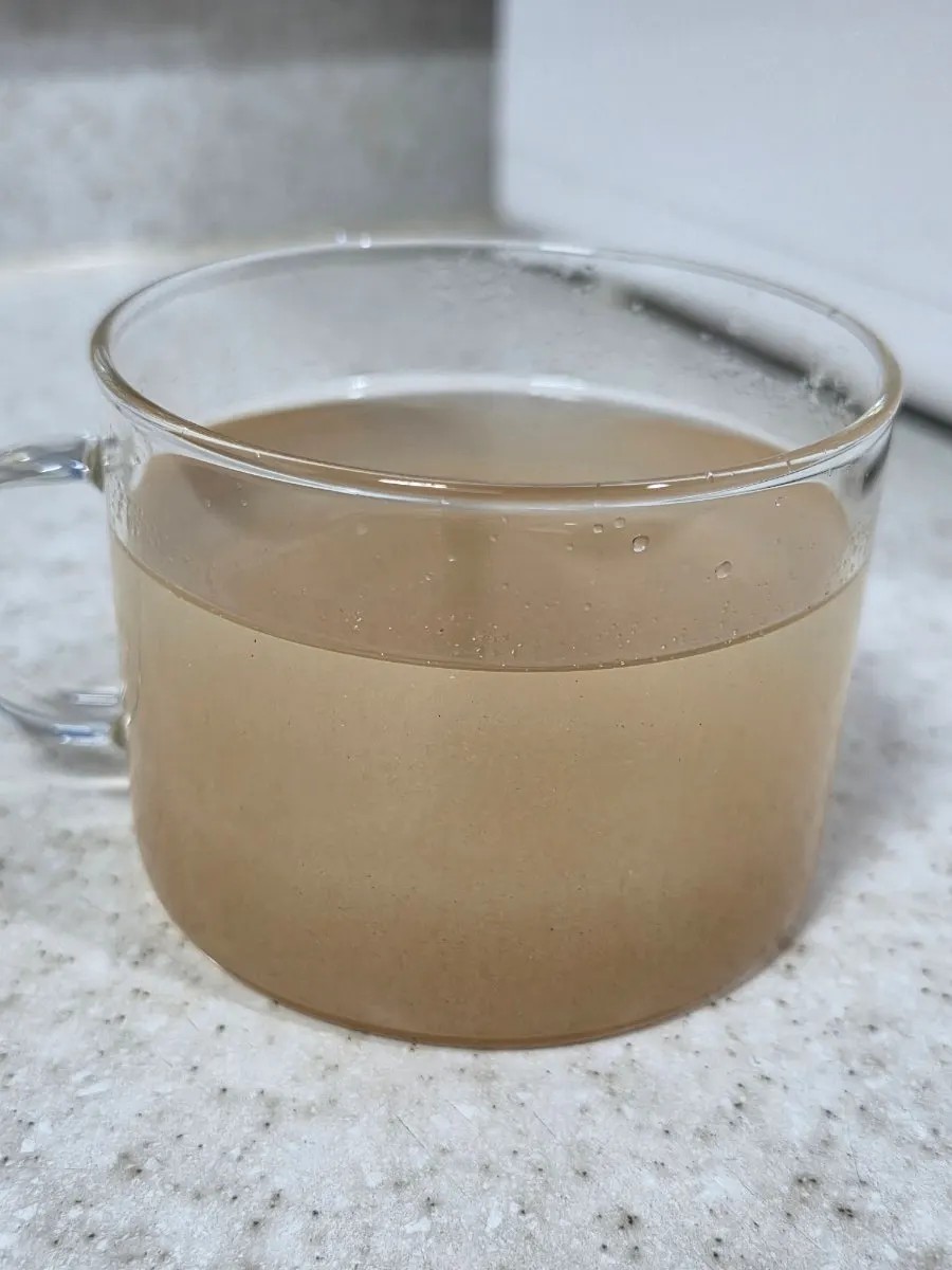 Cup of pineapple-flavored psyllium husk drink right before drinking