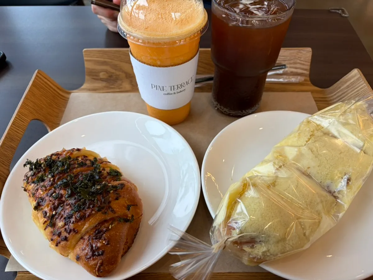 Table with pollack roe salt bread, milk soft roll, and drinks