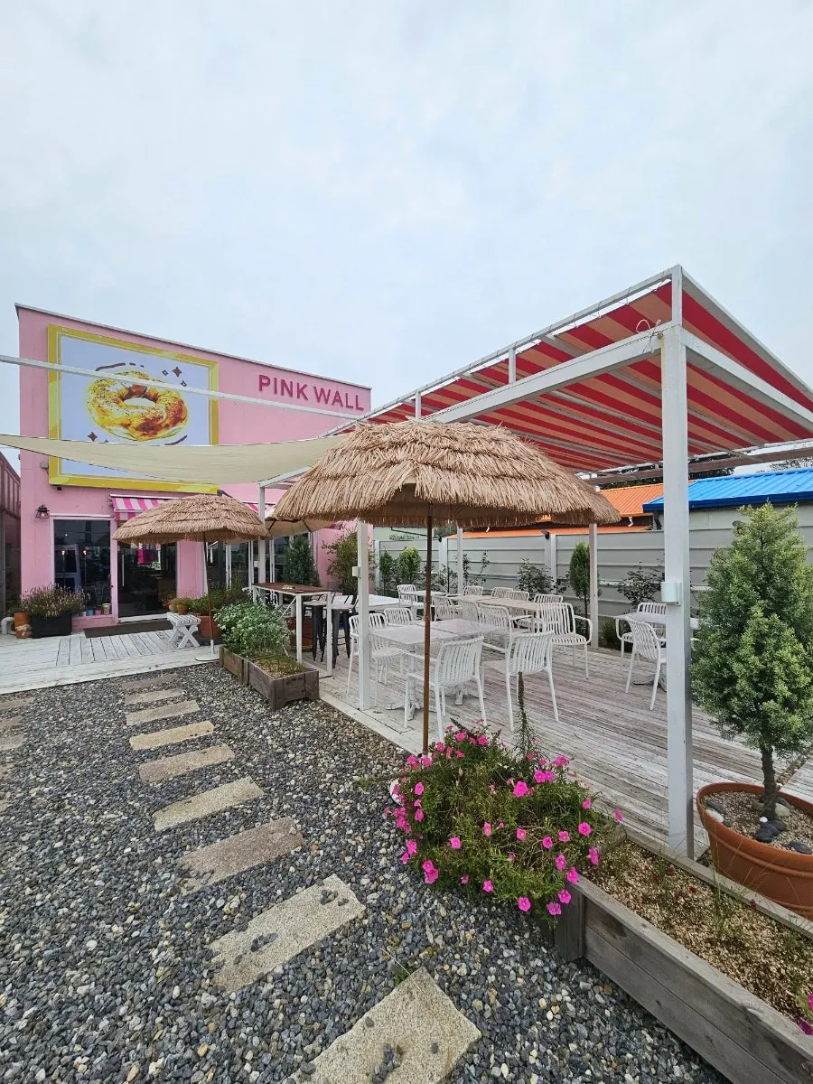 Outdoor terrace at Pink Wall Cafe overlooking a pond