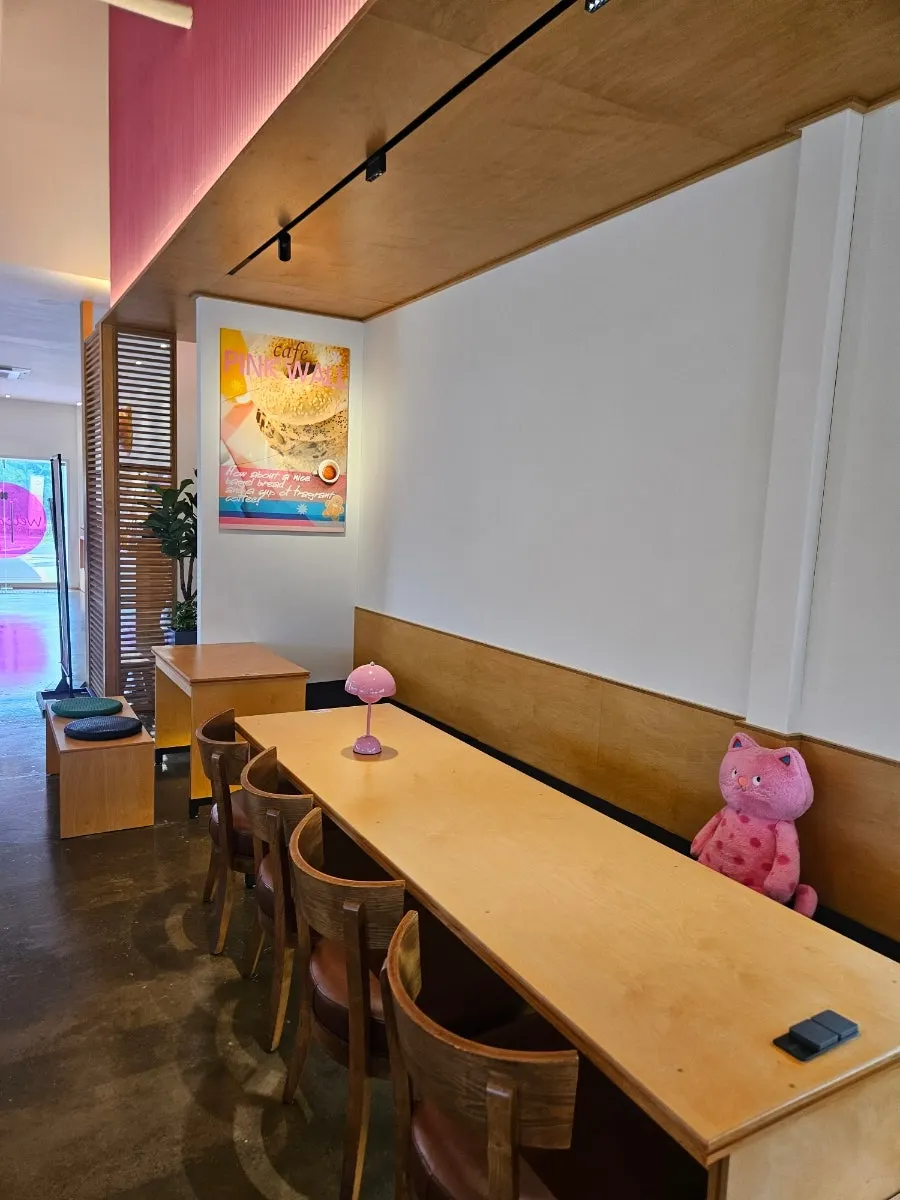 Wide view of the spacious interior seating at Pink Wall Cafe