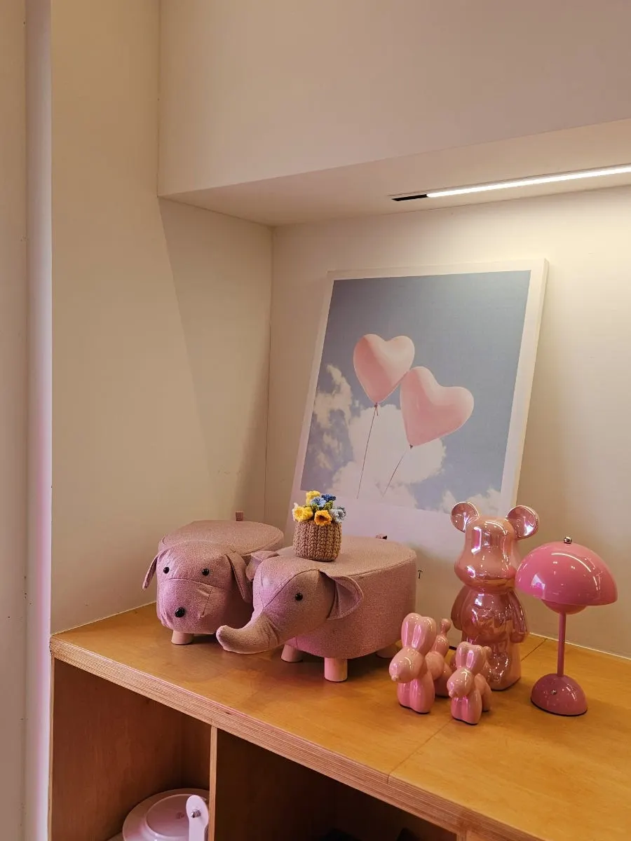 Wooden tables and chairs at Pink Wall Cafe