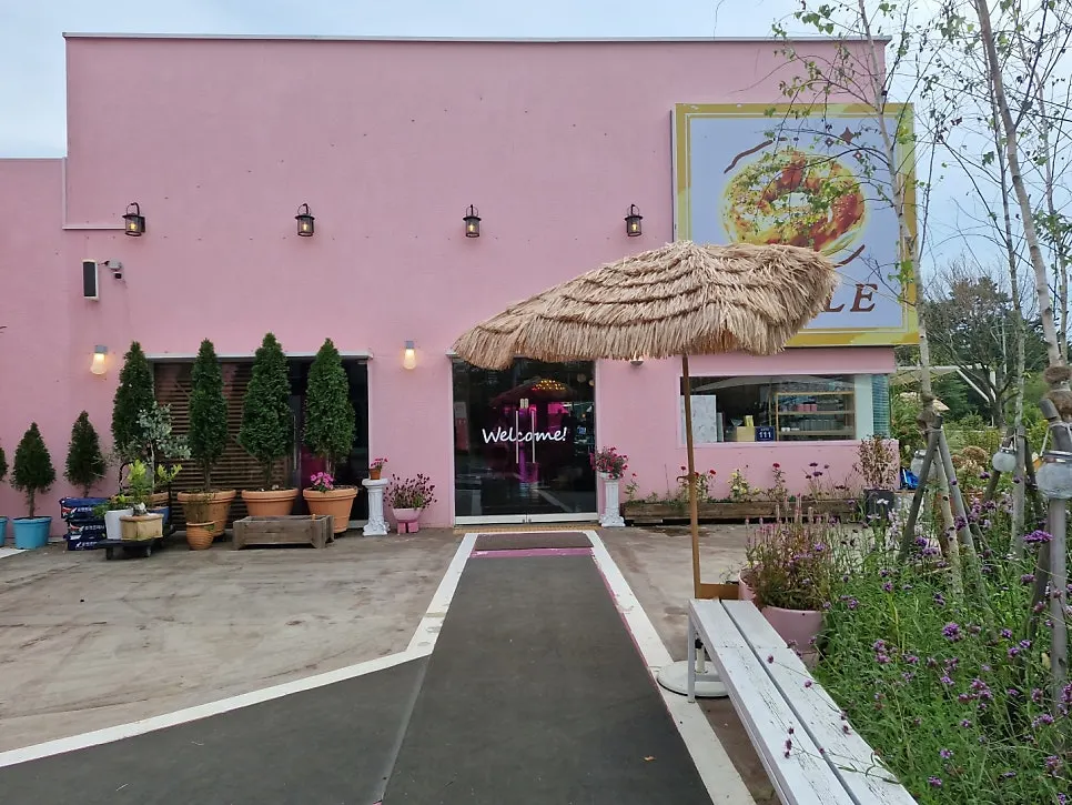 Exterior of Pink Wall Cafe with pink-painted walls