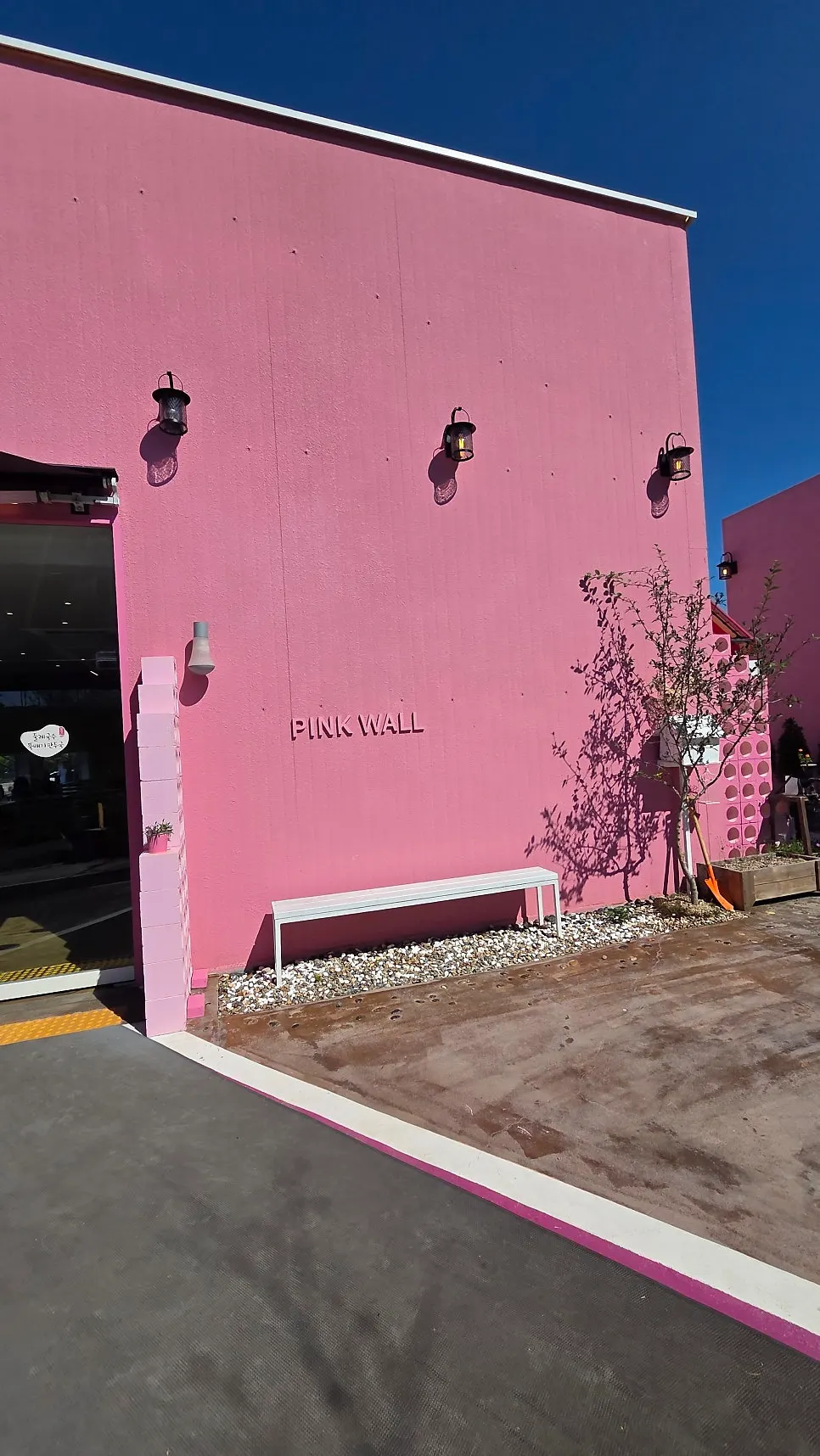 Photo zone at the entrance of Pink Wall Cafe