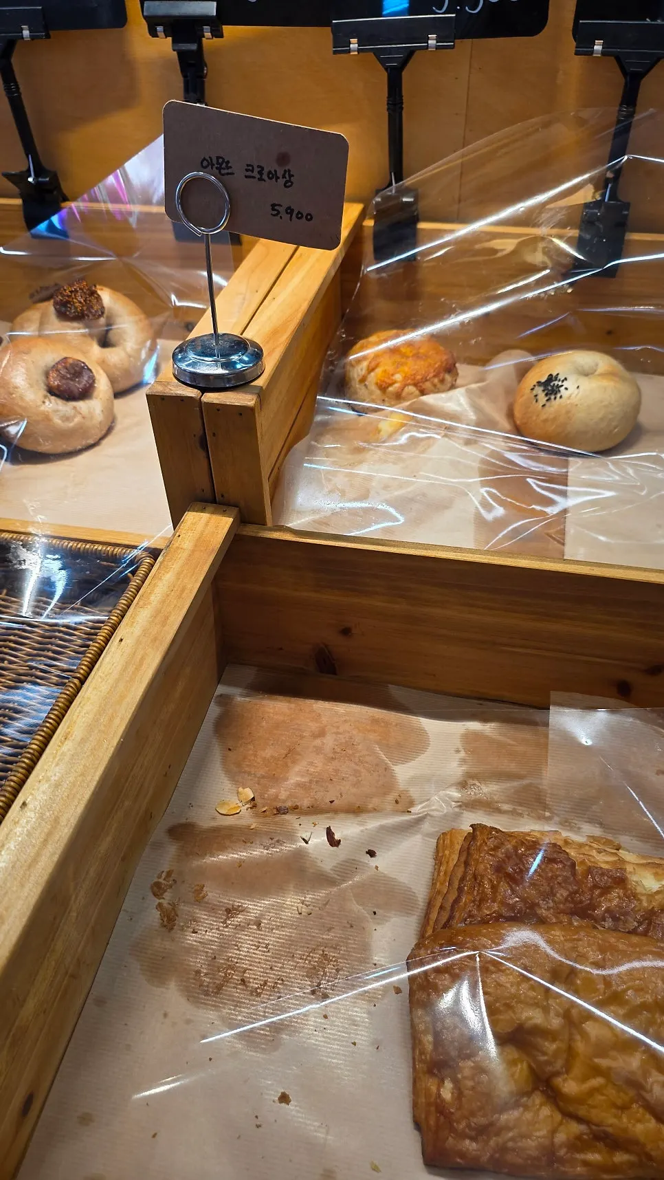 Vertical shot of the bread display case at Pink Wall Cafe