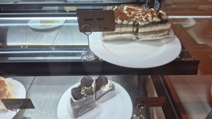 Chocolate cake and ham cheese bagel on the table