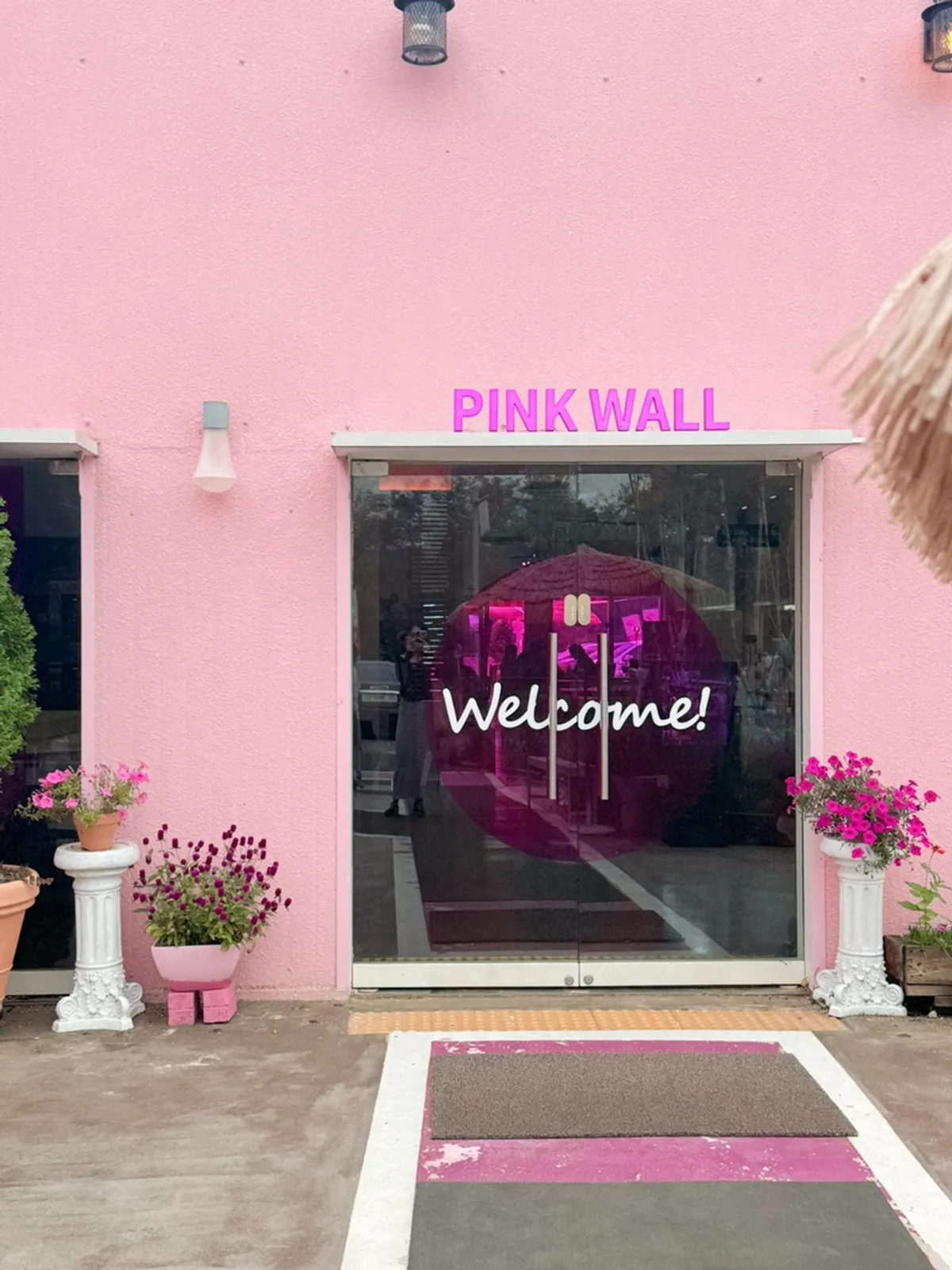 Pink-toned exterior view of Pink Wall Cafe