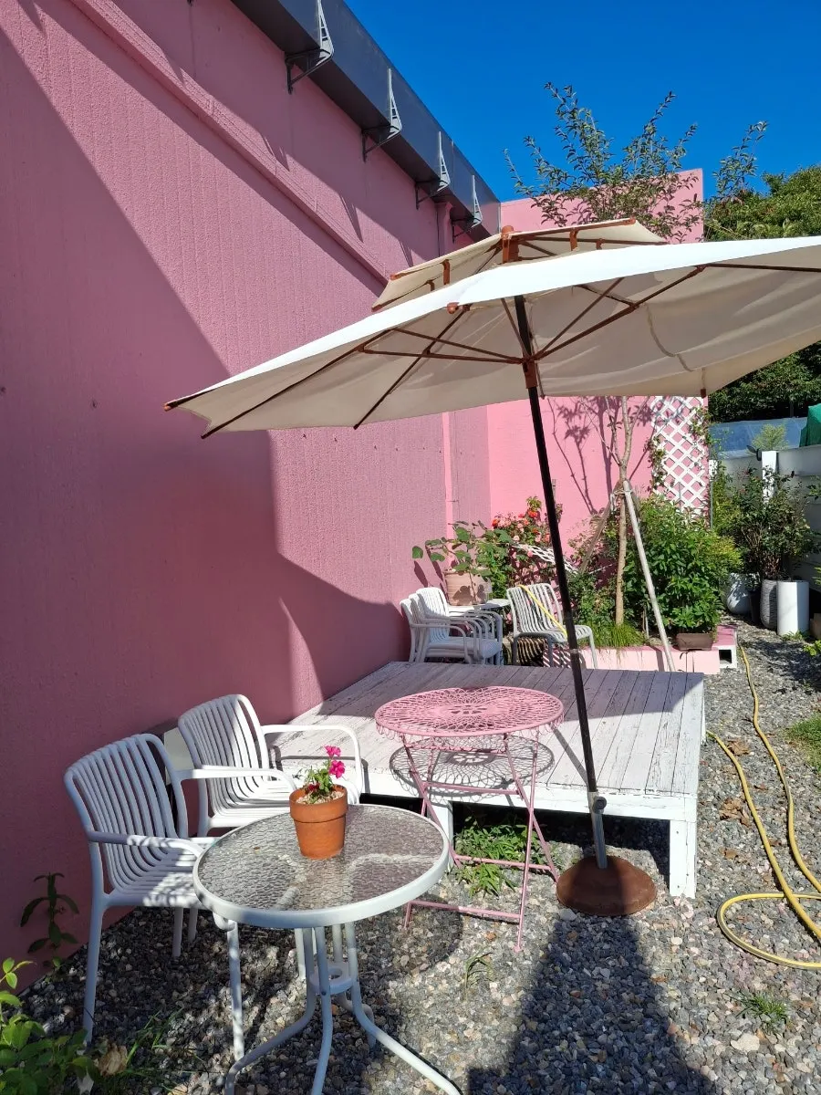 Green scenery visible from the terrace at Pink Wall Cafe