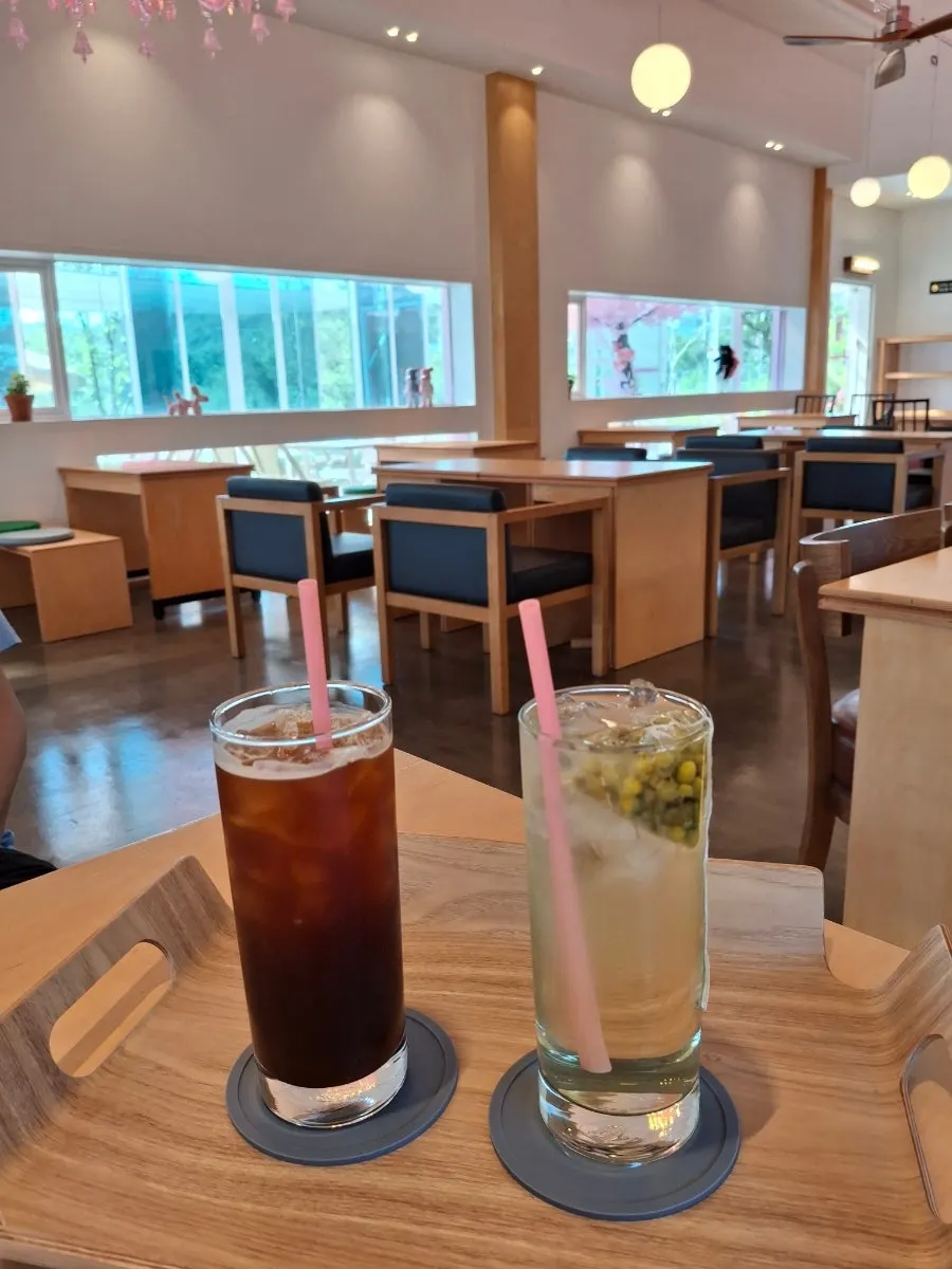 Iced Americano and chamomile tea on a café table