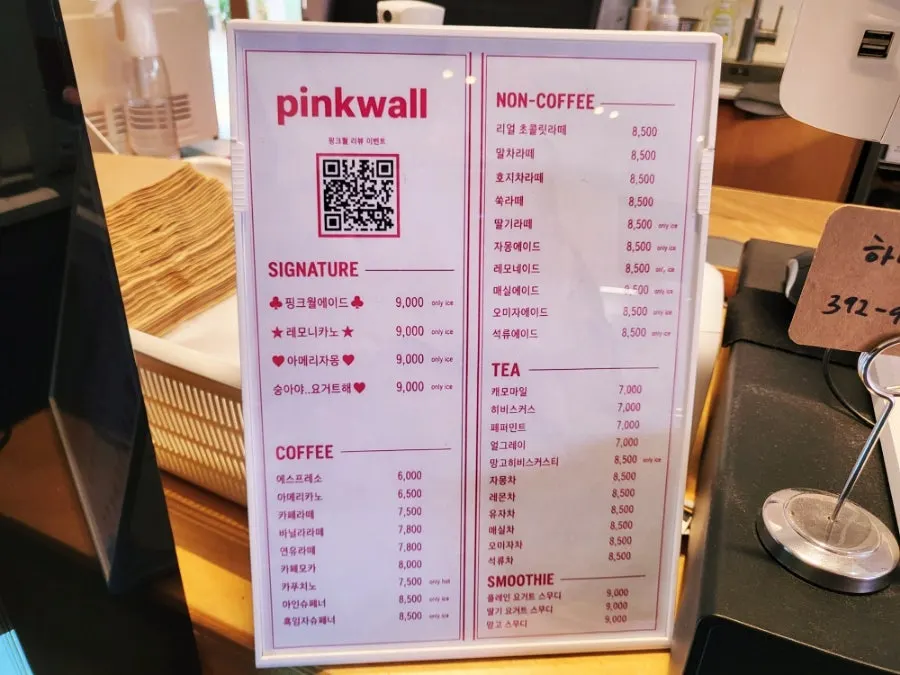 Interior of Pink Wall Cafe decorated with pink props