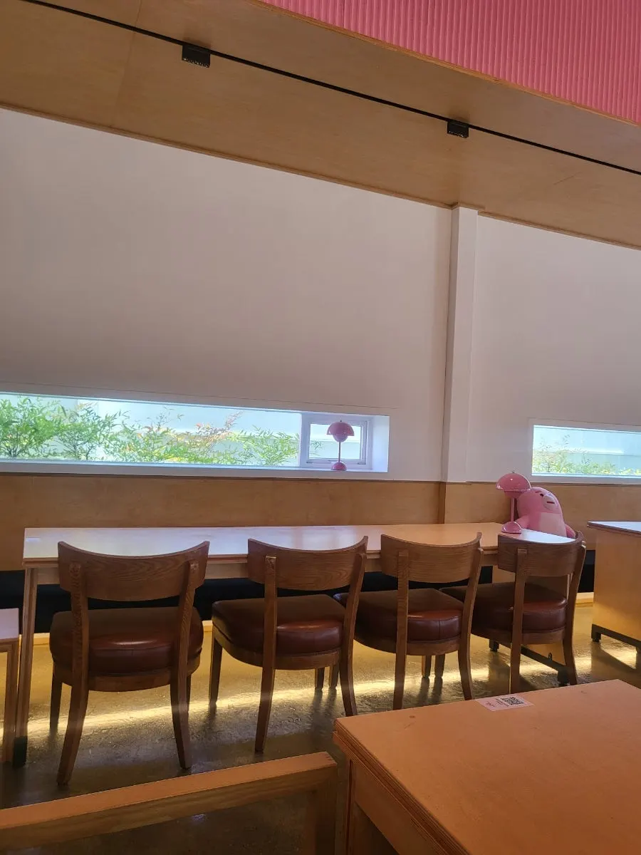 Indoor seating at Pink Wall Cafe with wide table spacing