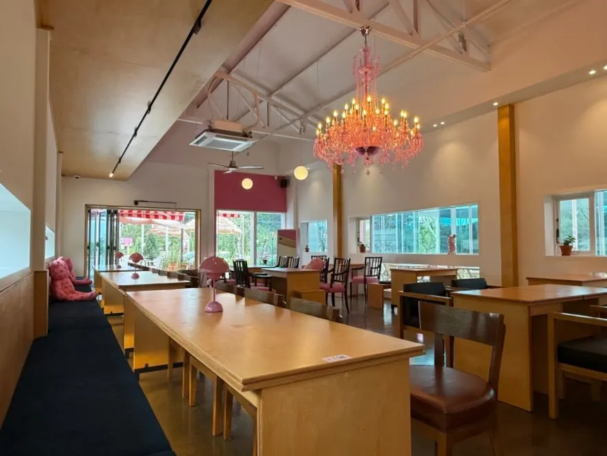 Wood-toned interior of Pink Wall Cafe with pink accents
